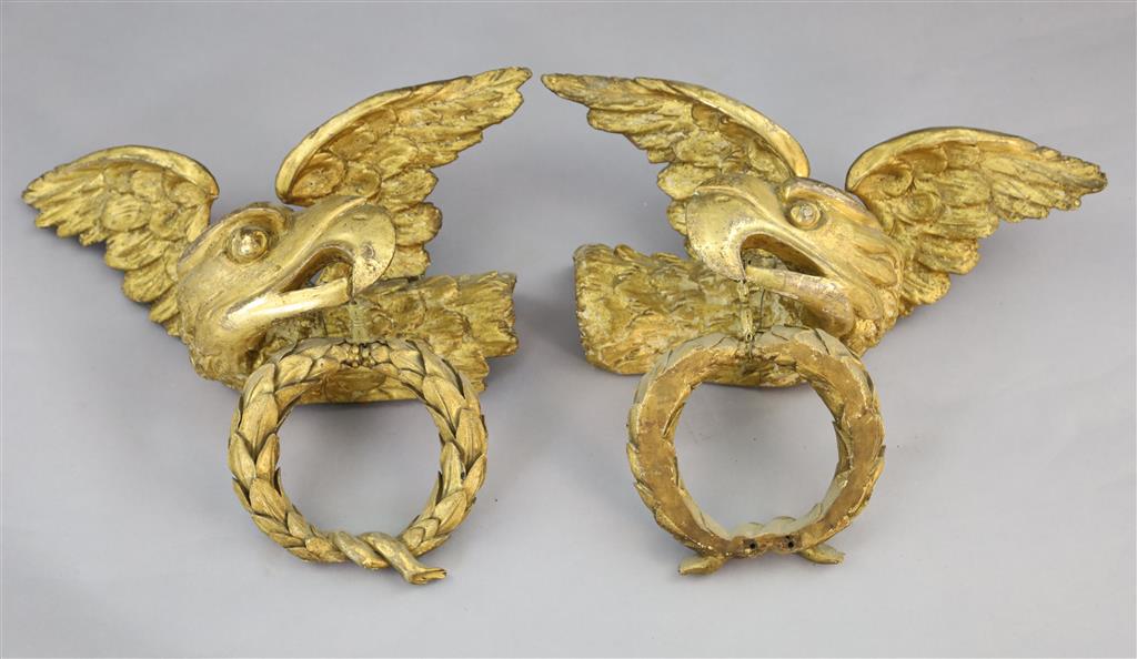 A pair of early 19th century carved giltwood and gesso wall appliqués, W.1ft 6in. H.1ft 6in.